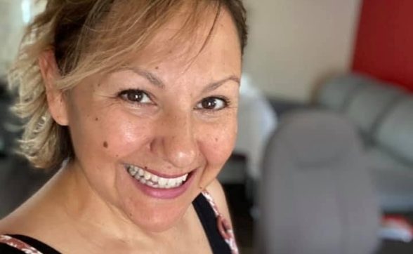 A woman posing for a selfie in an office.
